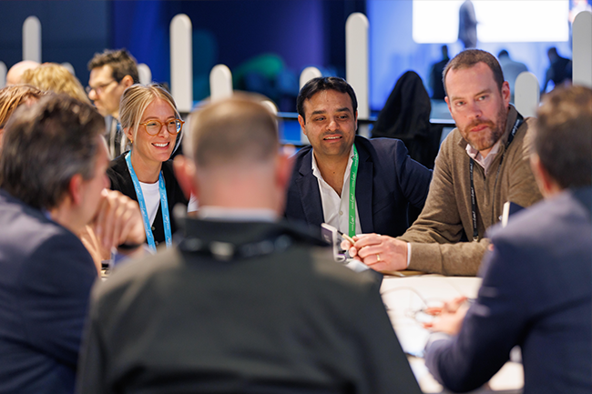 Attendeed meeting at a table in the Meeting Zone