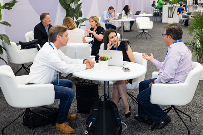 Attendeed meeting at a table in the Meeting Zone