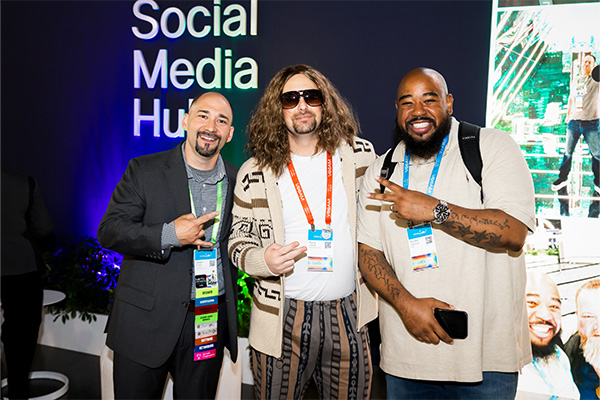 Three attendees posing in the Social Hub
