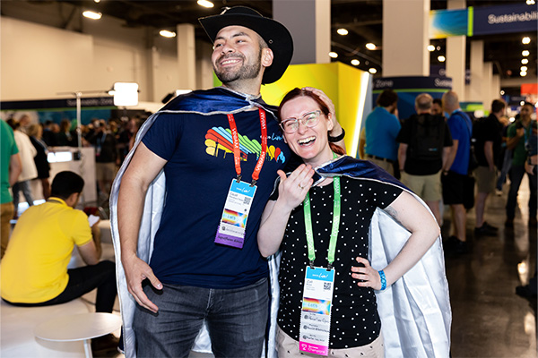 Two attendees wearing Cisco Live capes