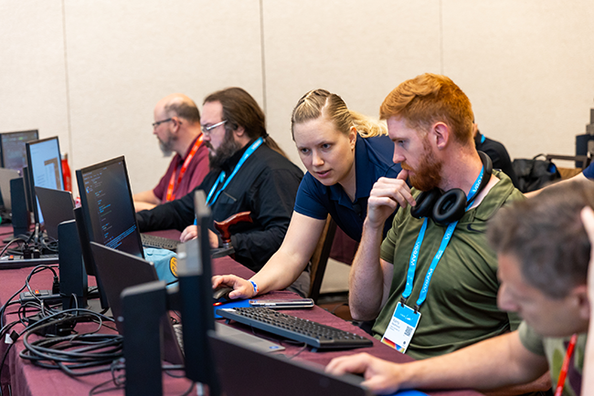 An instructor helping an attendee during a technical session